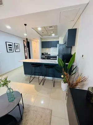 a kitchen with blue cabinets and stools in a room at Bay Central Sea and Canal View, Dubai Marina in Dubai