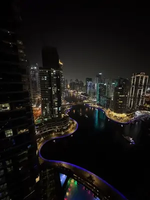 a city skyline at night with a river and buildings at Bay Central Sea and Canal View, Dubai Marina in Dubai