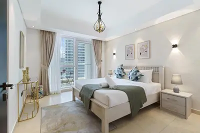 a bedroom with a large bed and a window at Neat and Cozy 2BR plus Kids Room - 7min to Dubai Mall in Dubai
