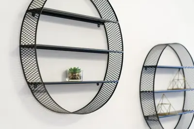 a pair of metal shelves on a wall at Neat and Cozy 2BR plus Kids Room - 7min to Dubai Mall in Dubai