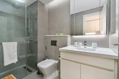 a bathroom with a toilet and a shower and a sink at Cloud 18 Studio - Business Bay in Dubai