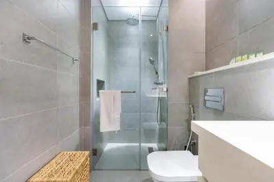 a bathroom with a shower with a toilet and a sink at Cloud 18 Studio - Business Bay in Dubai