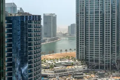 a view of a river between two tall buildings at Cloud 18 Studio - Business Bay in Dubai