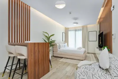 a living room with a couch and a table at Cloud 18 Studio - Business Bay in Dubai