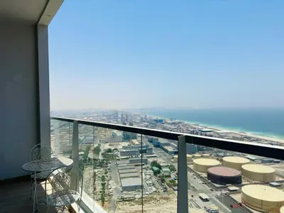 a room with a view of a city and the ocean at Sophisticated Fully Furnished and Family-Friendly in Dubai