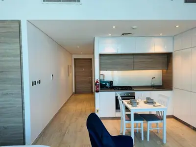 a kitchen and dining room with a table and chairs at Sophisticated Fully Furnished and Family-Friendly in Dubai