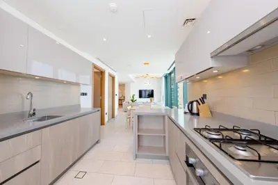a kitchen with a sink and a stove at Modern Living with Skyline Views in Hartland in Dubai