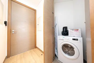 a laundry room with a washer and dryer at Modern Living with Skyline Views in Hartland in Dubai