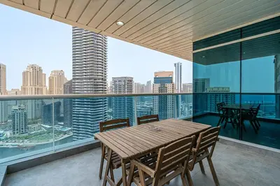 a dining room with a view of the city at 2BR with Marina Views - Near JBR Beach & Dubai Eye in Dubai