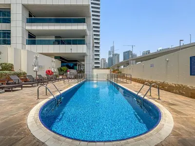a swimming pool in the middle of a building at 2BR with Marina Views - Near JBR Beach & Dubai Eye in Dubai