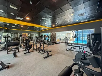 a gym with a lot of treadmills and machines at 2BR with Marina Views - Near JBR Beach & Dubai Eye in Dubai