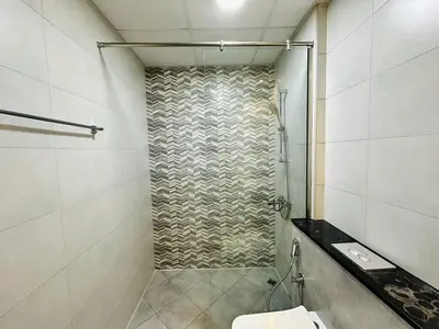 a bathroom with a shower with a toilet in it at Fully Furnished and High Floor Unit in Al Jaddaf in Dubai