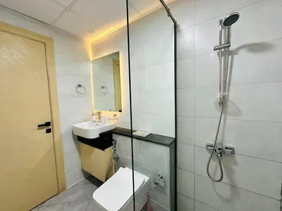 a bathroom with a shower and a sink and a toilet at Fully Furnished and High Floor Unit in Al Jaddaf in Dubai
