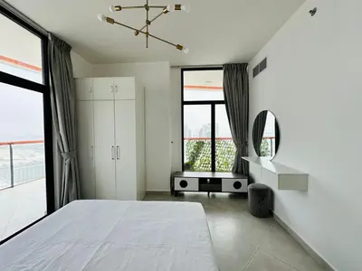a bedroom with a bed and a large window at Fully Furnished and High Floor Unit in Al Jaddaf in Dubai
