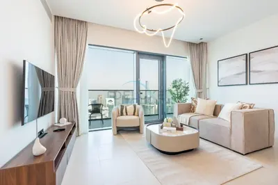 a living room with a couch and a table at High Rise Apartment with Direct Access to Marina Walk, Near JBR, Marina Mall and Dubai Dining Hotspots, VIDA Residences, Dubai Marina by Deluxe Holiday Homes in Dubai