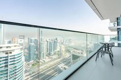 a table on the balcony of a building with a city at High Rise Apartment with Direct Access to Marina Walk, Near JBR, Marina Mall and Dubai Dining Hotspots, VIDA Residences, Dubai Marina by Deluxe Holiday Homes in Dubai