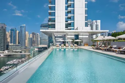 a swimming pool with a view of a building at High Rise Apartment with Direct Access to Marina Walk, Near JBR, Marina Mall and Dubai Dining Hotspots, VIDA Residences, Dubai Marina by Deluxe Holiday Homes in Dubai