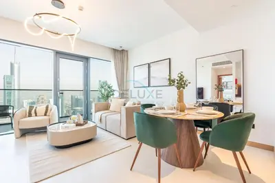 a living room with a table and chairs at High Rise Apartment with Direct Access to Marina Walk, Near JBR, Marina Mall and Dubai Dining Hotspots, VIDA Residences, Dubai Marina by Deluxe Holiday Homes in Dubai