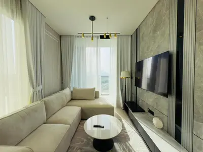 a living room with a couch and a tv at Private Pool II Spacious II Brand New in Dubai