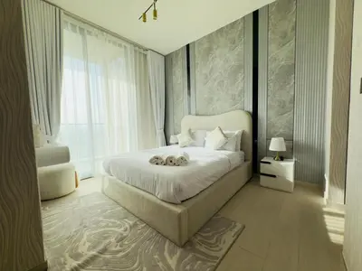 a bedroom with a large bed and a large window at Private Pool II Spacious II Brand New in Dubai