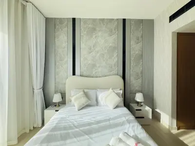 a bedroom with a white bed with white pillows at Private Pool II Spacious II Brand New in Dubai