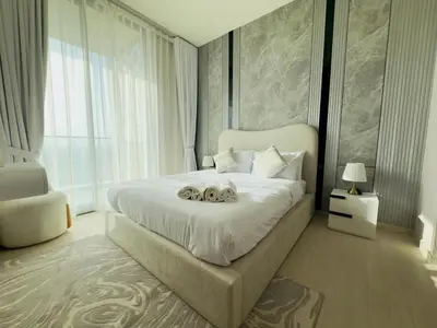 a bedroom with a large white bed with two dogs on it at Private Pool II Spacious II Brand New in Dubai