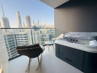 a kitchen with a balcony with a view of a city at Brand New with Private Jacuzzi in Dubai