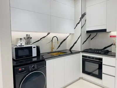 a kitchen with a microwave oven and a dishwasher at Brand New with Private Jacuzzi in Dubai