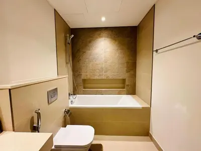 a bathroom with a bath tub and a toilet at Zabeel View I Fully Furnished I Prime Location in Dubai