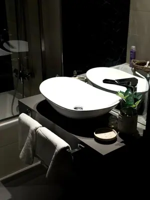 a bathroom with a white sink and a mirror at Best Canal View Studio in AG Tower Business Bay in Sabkhah