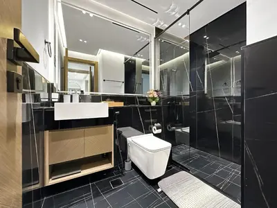 a bathroom with a toilet and a sink and a shower at 1-Bedroom Apartment in Downtown with Pool View in Dubai