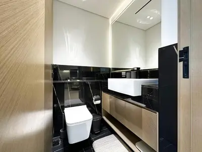 a bathroom with a toilet and a sink at 1-Bedroom Apartment in Downtown with Pool View in Dubai