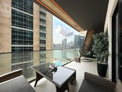 a room with a large window with a view of the city at 1-Bedroom Apartment in Downtown with Pool View in Dubai