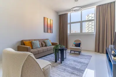 a living room with a couch and chairs at The Smart Concierge - Damac 108 in Dubai