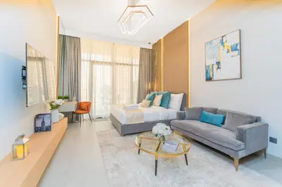 a living room with a couch and a bed at Escape24 Cozy Studio with Infinity Pool in JVC in Dubai