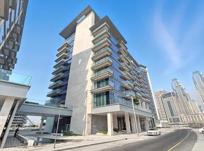a tall building on the corner of a street at Jumeirah Waterfront Residences in Dubai