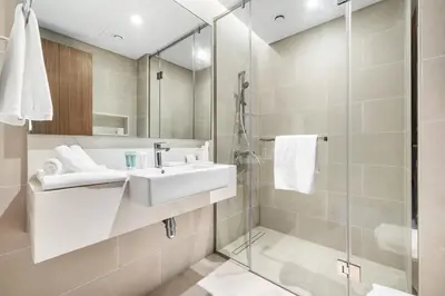 a bathroom with a sink and a shower at Jumeirah Waterfront Residences in Dubai