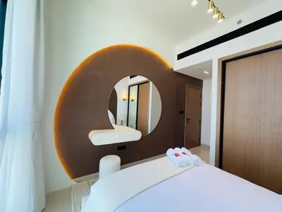 a bedroom with a round mirror and a bed at High-End Furnished Homey Elegant with Private Pool in Dubai