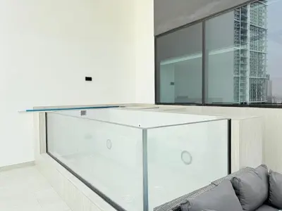 a living room with a glass counter and a couch at Brand New with Installed Private Pool in Balcony in Dubai