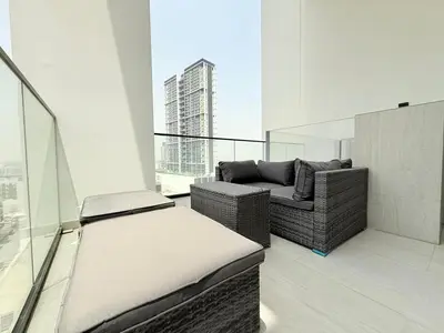 a balcony with a couch and a bed on a building at Brand New with Installed Private Pool in Balcony in Dubai