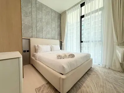 a bedroom with a white bed with a large window at Brand New with Installed Private Pool in Balcony in Dubai