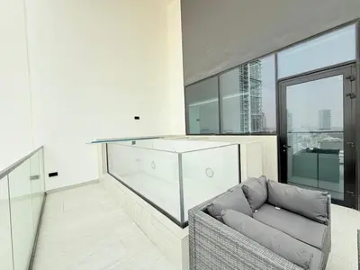 a living room with a couch and a large window at Brand New with Installed Private Pool in Balcony in Dubai