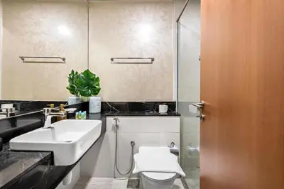 a bathroom with a sink and a toilet and a mirror at Stylish Furnished Apartment with Burj Khalifa View, High Floor in Dubai