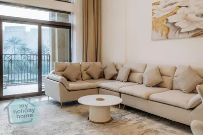 a living room with a couch and a table at Luxurious Apartment in the Heart of Dubai in Dubai