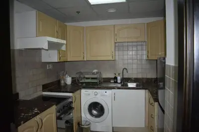 a kitchen with a washing machine and a sink at Cozy 2BR -Near JBR Beach &Metro in Dubai