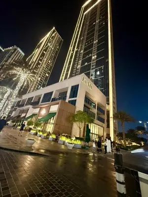 a large building in front of some tall buildings at Giramondo Forte Tower 1 in Dubai