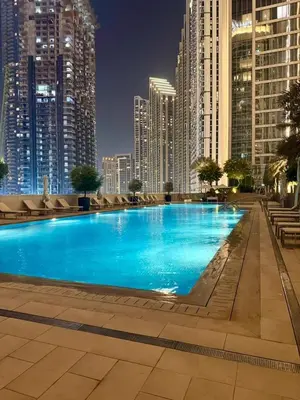 a large swimming pool in a city with tall buildings at Giramondo Forte Tower 1 in Dubai