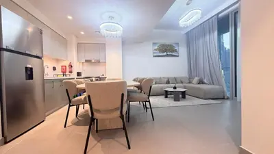 a kitchen and a living room with a table and chairs at Giramondo Forte Tower 1 in Dubai