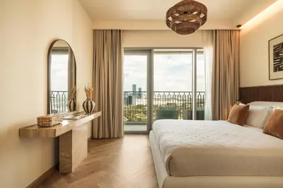 a bedroom with a bed and a large window at Seraya Residence 19 - 4BDR - 180 Burj View & DIFC views in Dubai