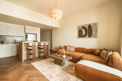 a living room with a couch and a table at Seraya Residence 19 - 4BDR - 180 Burj View & DIFC views in Dubai